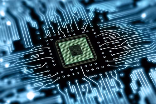 Close-up of a computer microchip with glowing blue circuitry lines extending outward.